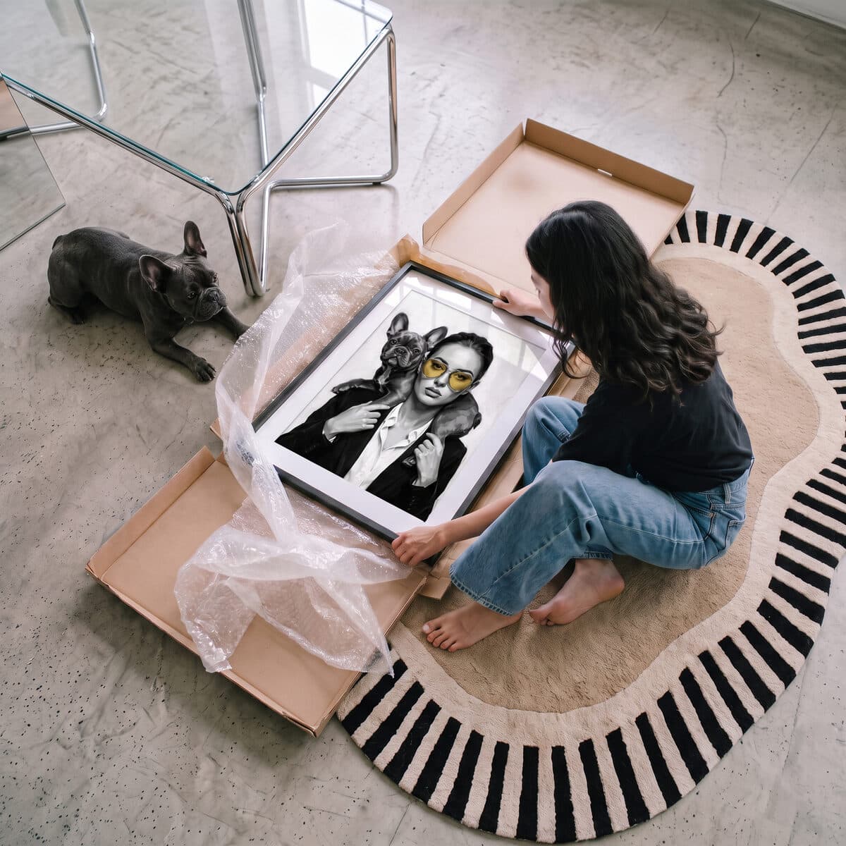 A framed pet portrait being unwrapped